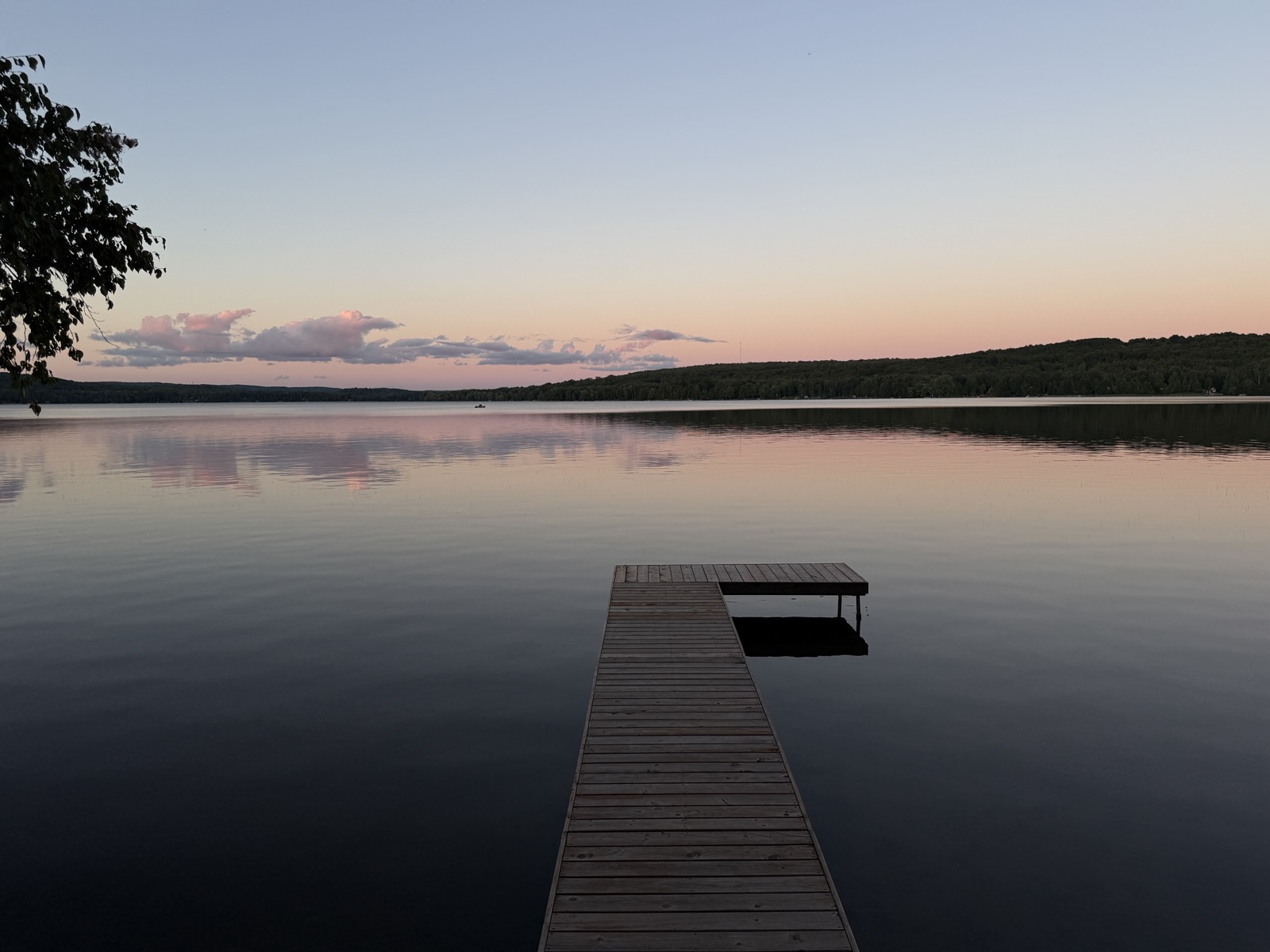The dock at dusk on still water